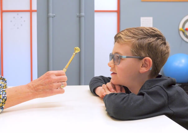 boy taking pediatric eye exam at Eyes Strong Pediatric Eye Care