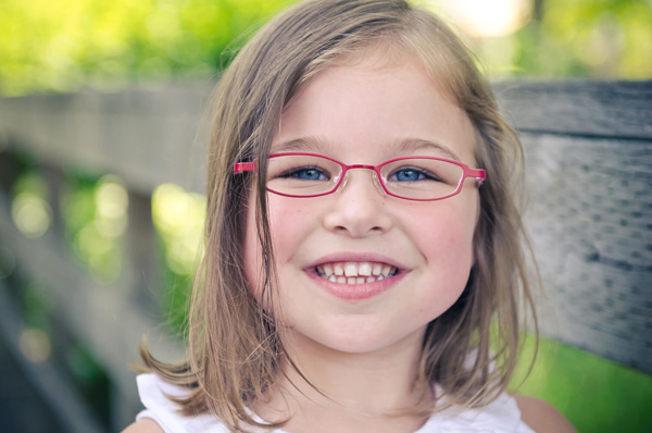 young girl wearing eyeglasses at Alberta Eye Care