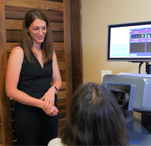 doctor scanning patients eye while explaining at Alberta Eyecare